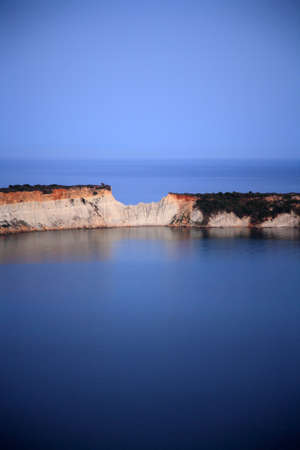 blue sea and sky with small mountain in the midle