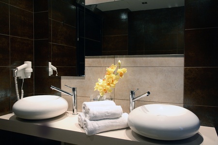 interior of a luxury bathroom with towels and flowers