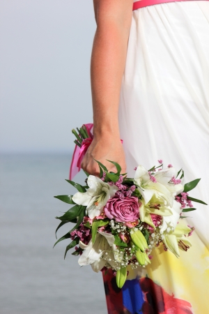 close up of a female  hand holding a flower bouquet の写真素材