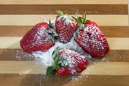 closeup of fresh strawberries with sugar powder on top の写真素材