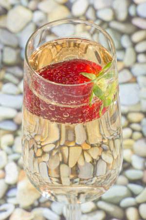 fresh strawberry on a glass filled sparkling wineの写真素材