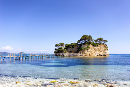 small island with wooden bridge crossing the shore  in Zante,Greeceの写真素材