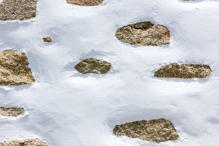white wall with stones background textureの写真素材