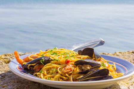 seafood with pasta by the sea in a greek islandの写真素材