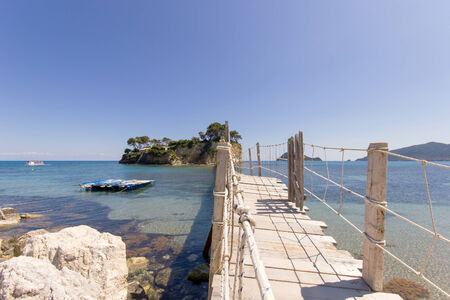 small island with wooden bridge that crossing the seaの写真素材