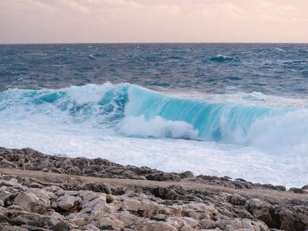 sea with waves and sky with clouds in the afternoonの写真素材