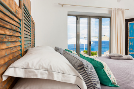 interior of a bedroom with beautiful decoration in a summer resort in Greeceの写真素材