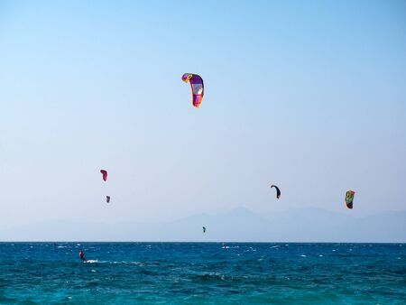 kite surfers sailing in big waves in the island of Leukada in Greeceの写真素材