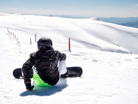 Kalavrita, Greece - MARCH 17, 2017:Snowboarder  at the top of the mountain in Kalavrita ski resortの写真素材