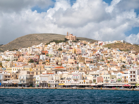SYROS, GREECE - APRIL 10, 2016: View of Syros town with beautiful buildings and houses in a sunny...