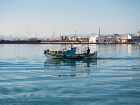 Fishing boat leaving the port of Kalamata, Greeceの写真素材