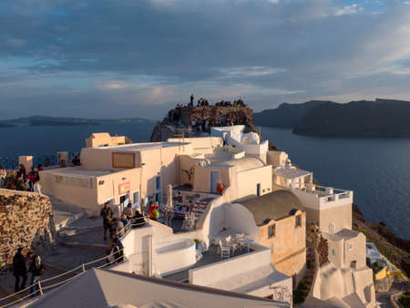 SANTORINI, GREECE- APRIL 13, 2017:People watch the sunset in Santorini island in Cyclades, Greeceのeditorial素材