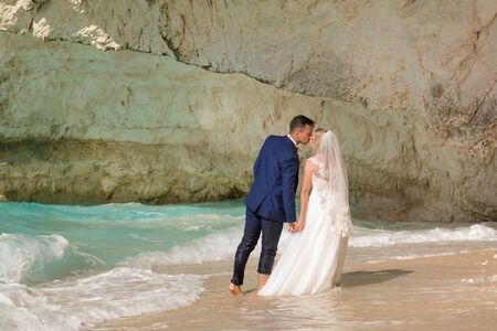 Beautiful bride and groom alone at the beach of a Greek islandの写真素材