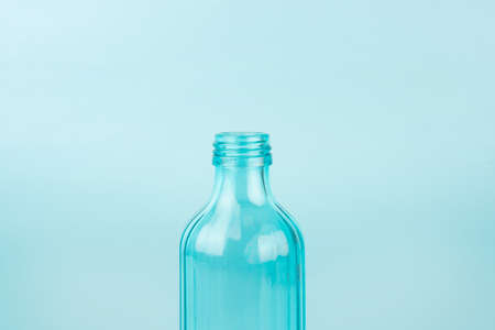 Blue glass bottle. Isolated on blue background. Concept of reusable containers