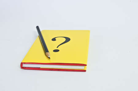 Question book with pencil on white backgroundの写真素材