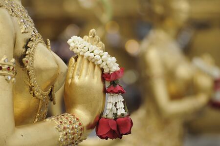 Close-up hand of Golden statue of Kinara at Wat Phra Kaew in Bangkok, Thailandの写真素材