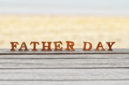 Happy father day concept, word of wooden father day on wood on beach background ideaの写真素材
