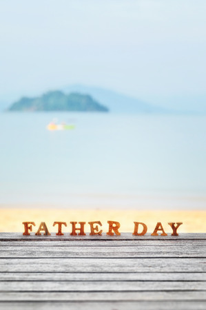 Happy father day concept, word of wooden father day on wood on beach background ideaの写真素材