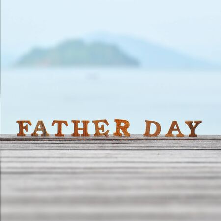 Happy father day concept, word of wooden father day on wood on sea view background ideaの写真素材
