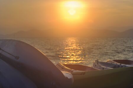 Sunrise with kayak boat on tropical beach background, happy summer holiday conceptの写真素材