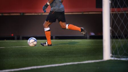 Goalkeeper soccer with ball in the stadiumの写真素材