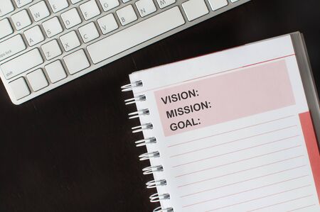 Words of vision, mission and goal on note book with keyboard, business concept and success ideaの写真素材