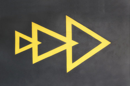 Yellow triangle on wall backgroundの写真素材