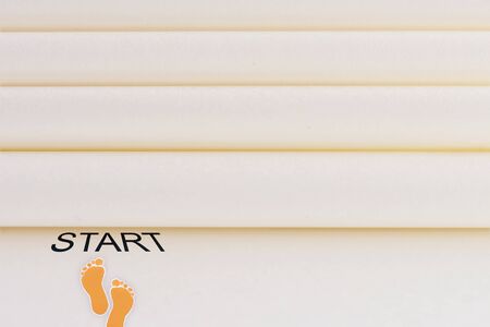 Start walking, start word written on paper with footstep
