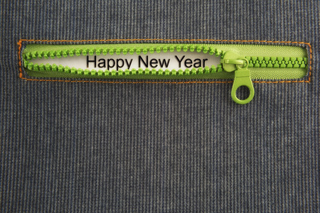 Happy new year word with green zip on jeans backgroundの写真素材