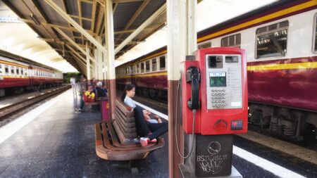 BANGKOK THAILAND - JULY 9, 2017: Public telephone and local people waiting for train at Bangkok...