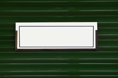 Blank white sign on green steel backgroundの写真素材