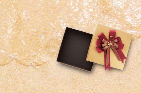 Blank gold box on tropical beach background with soft wave idea