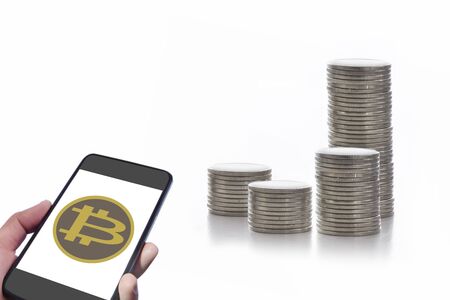 Smartphone with bitcoin exchange and stack of coins on white background, cryptocurrency technology...