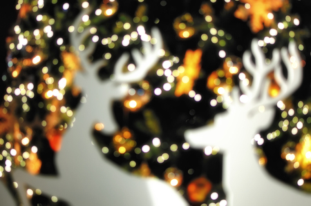 Blur christmas deer on abstract bokeh night background, merry christmas concept and abstract ideaの写真素材