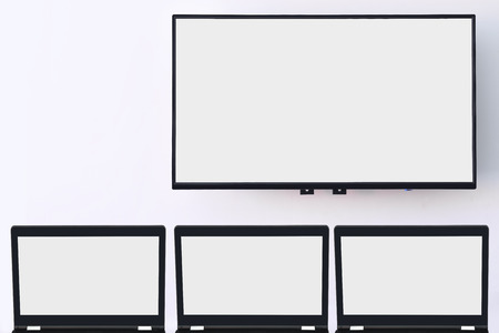 White screen computer and white wide screen smart TV digital hanging on white wall background, online training concept and copy space and input text ideaの写真素材