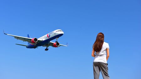 PHUKET, THAILAND - MARCH 26, 2018: Tourist looking at Azur Air Boeing 757-2Q8 (WL) VQ-BEZ landing at...