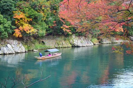 Kyoto, Japan - November 26, 2019: Traveler riding boat at Hozu river in Autumn season at Arashiyama area in Kyoto, Japanのeditorial素材