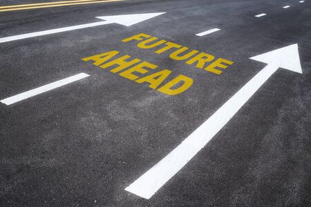 Road to future, future ahead word on asphalt road with arrow, business challenge concept and business success ideaの写真素材
