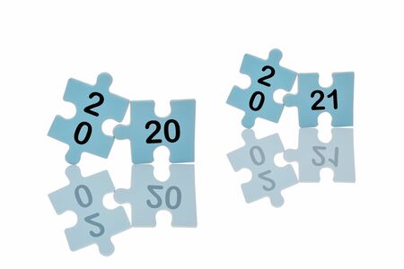New year 2020 and 2021 on blue puzzle with reflection on white background, business concept and success ideaの写真素材