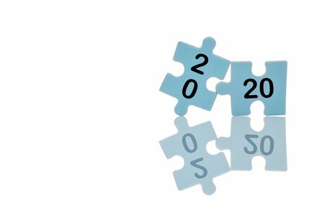 New year 2020 on blue puzzle with reflection on white background, business concept and success ideaの写真素材