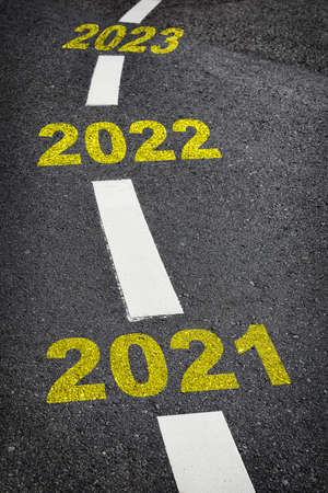 New year 2021 to 2023 on black asphalt road and white marking lines, Happy new year and road to...
