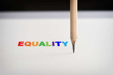Equality word and pencil on white paper on black background. Social issue concept and lgbt idea