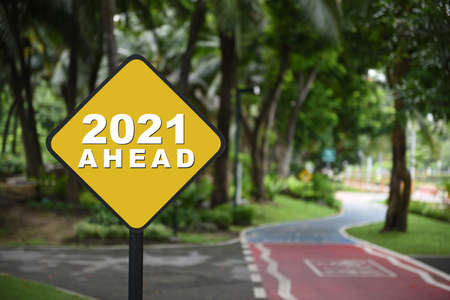 2021 future ahead word on yellow traffic sign on bike lane background. Challenge concept and effort direction ideaの写真素材