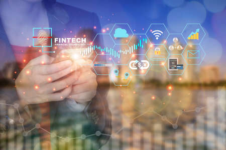 Businesswoman using smart phone working with new modern technology on cityscape background....