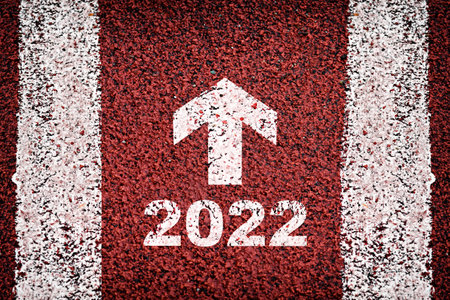 New year 2022 and white arrow on road surface with marking lines. Future ahead concept and never...