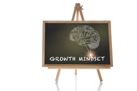Growth mindset word and brain human drawing on chalkboard isolated on white background. Potential development concept and good attitude motivation ideaの写真素材