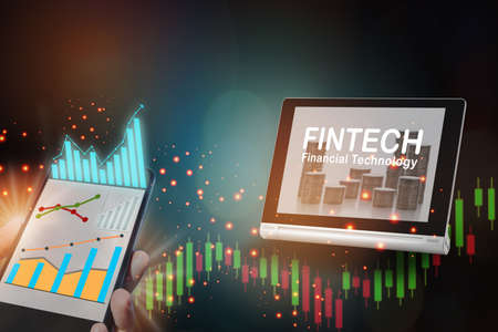 Growth graphs on smartphone and financial technology on computer tablet on abstract background. Artificial intelligence innovation concept and return on investment ideaの写真素材
