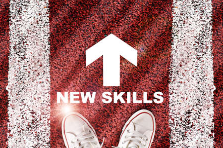 New skills word and white arrow written on road surface with marking lines. Future ahead concept and self development ideaの写真素材