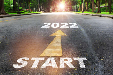 Start to 2022  written on the road on nature background with sunlight. Business planning concept and new year beginning success ideaの写真素材