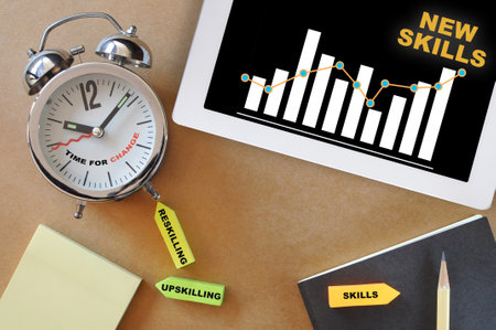 Time for change concept and self improvement with reskilling and upskilling idea. New skills and growth graph on computer digital tablet on working deskの写真素材